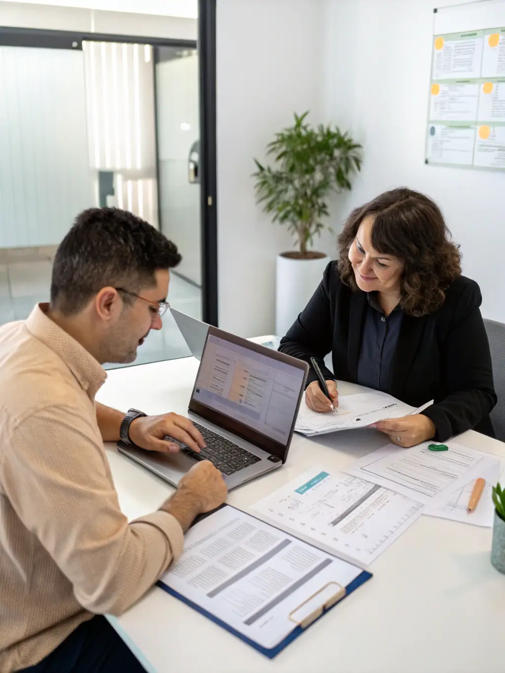 A professional accountant reviewing financial statements with a small business owner in a modern office setting, emphasizing collaboration and expertise.